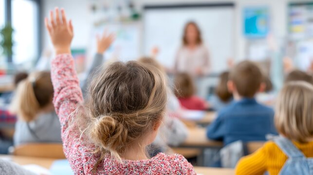 Students engage in classroom learning with hands raised to ask questions