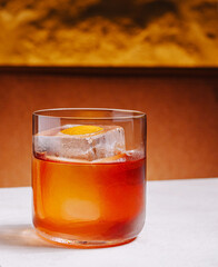 Craft cocktail with ice and orange garnish served in a glass