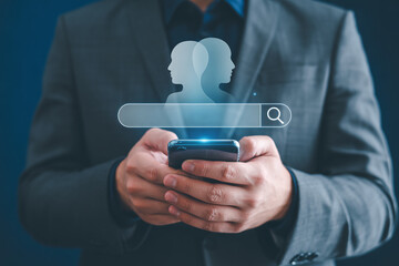 Man using a smartphone for job search with a holographic interface showing profiles and a search bar for recruitment and human resources
