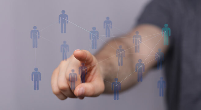 Hand pointing at connected people representing networking, digital, communication, and social media. Teamwork a
