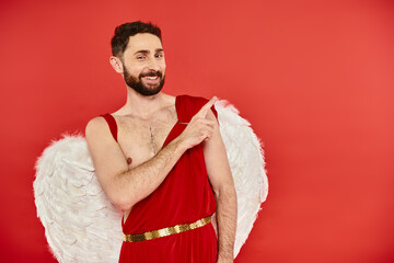 Fototapeta premium Cupid spreads love on Valentines Day dressed in red with fluffy wings