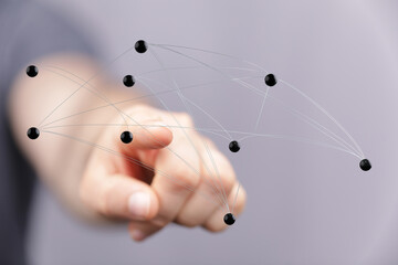 Hand pointing at a network of connections symbolizing technology, communication, and global data exchange. Conc