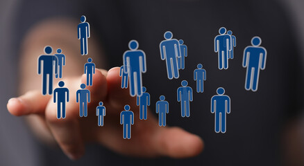 Hand reaching towards floating blue human icons, symbolizing teamwork, networking, and social connection. Digit