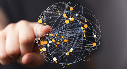 Abstract image showing interconnected network of lines and dots, held in a person's hand,...