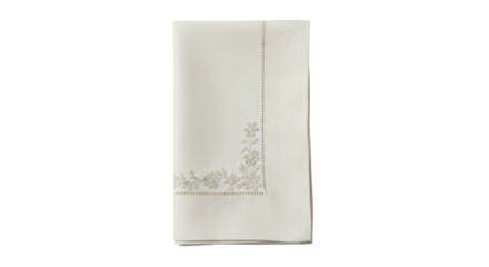 Isolated folded linen tablecloth with beige embroidered floral pattern border design