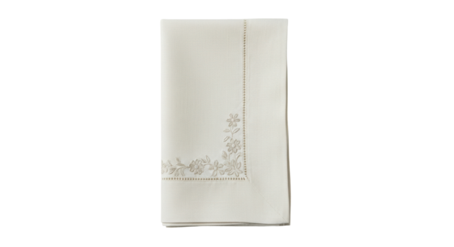 Isolated folded linen tablecloth with beige embroidered floral pattern border design