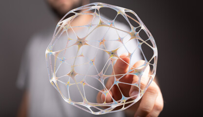 Close-up of a hand holding an illuminated abstract sphere structure representing connections, technology, future. Perfect for science