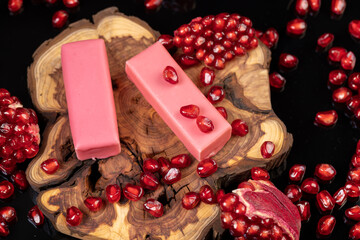 red ripe peeled pomegranate with large juicy grains and sweet curd cheese in pink glaze, sweet red pomegranate seeds and curd sweet products