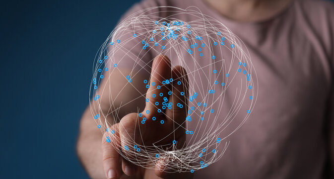 Person interacting with a digital network sphere, representing global connection, technology, and futuristic concepts.