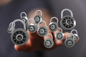 A close-up of a hand with several combination locks, symbolizing safety, protection, and data...
