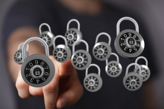Hand pointing at combination lock represents online security, privacy, protection and safety of data or digital