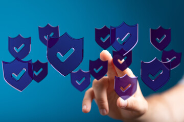 Concept of digital security with hand interacting with shields. This image represents data protection, cyber security, validation and