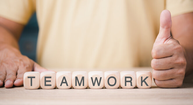 A young businessman with a wooden block line of leadership represents teamwork, business ideas and supportive friendships and cooperation of employees and friends. for the success of the organization