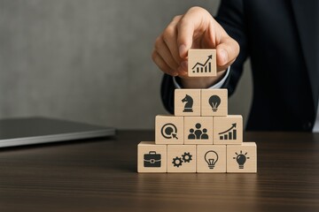 Business professional arranging wooden blocks with growth symbols, representing strategic thinking and planning. Concept of innovation, teamwork, and success in the corporate world.