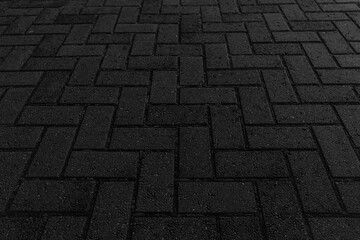 A close-up of dark brick paving with a 