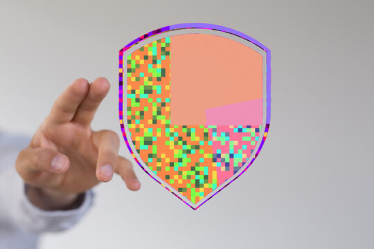 Hand holding a digitally represented shield, symbolizing security, data protection, and online safety. Concepts of privacy and cyber