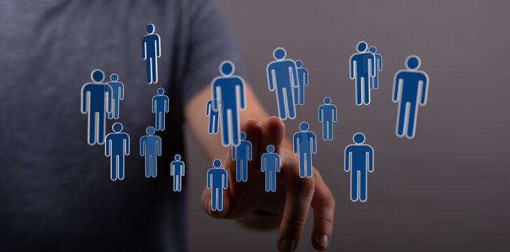 Hand reaching towards a network of digital people icons, representing connections and community, global concept - Powered by Adobe