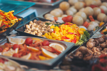Colorful spread of fresh vegetables and fruits at a market during a sunny afternoon in summer