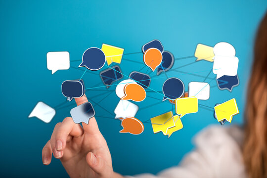 Abstract image of a person's hand interacting with speech bubble icons representing communication and social me