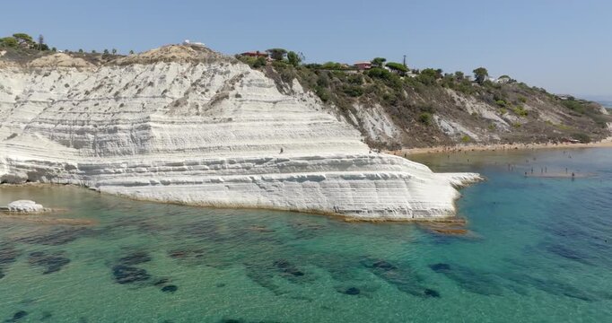 Aerial view of the Scala dei Turchi (Stair of the Turks or Turkish Steps) on coast of Sicily, Italy. It's a rocky cliff formed by marl, a sedimentary rock with white color. It overlooks turquoise sea.