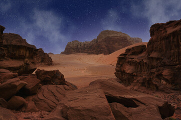 Vast desert landscape under a dramatic twilight sky filled with stars. Wadi Rum Desert, Jordan.