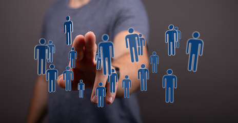 Hand pointing at floating digital people icons, representing connections, social networking, and teamwork conce