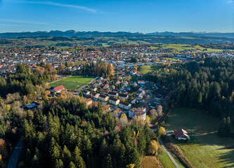 Obraz premium Aerial photo at sunset of the city of Lindenberg with surrounding forest and mountains in the western Allgaeu in Bavaria, Germany