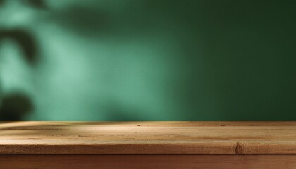 Wood table on dark green texture wall background. Composition with leaves shadow on the wall and light reflections. Mock up for presentation, branding products, cosmetics food or jewelry.
