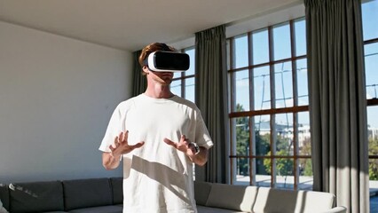 Young man using a VR headset in a bright living room, symbolizing virtual reality, innovation, and immersive digital experience.