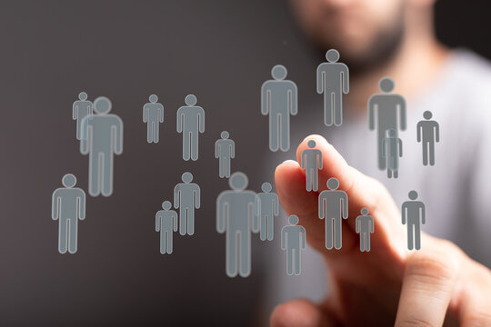 Man touching virtual human icons, symbolizing teamwork, networking, recruitment, community, and social media. D - Powered by Adobe