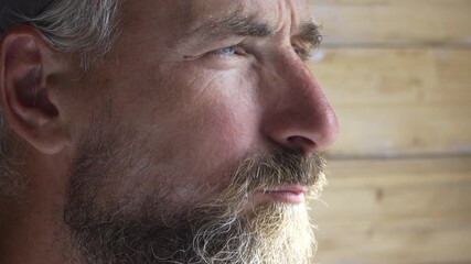 Man thoughtful beard, close-up profile of a mature bearded man looking away with a pensive expression - Powered by Adobe