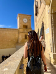Tourist walking in mdina, malta, admiring ancient clock tower © Ivi - Powerlightss