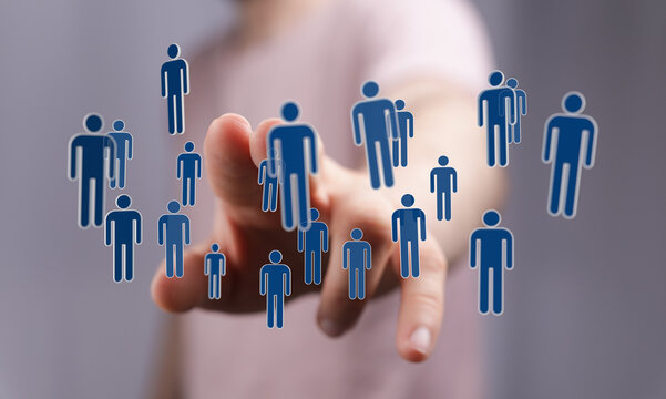 Close-up of a hand pointing at floating human icons representing connections, team work, or social media.