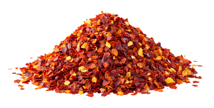 Dried red chili flakes piled on a white background showcasing their vibrant color and texture for culinary use