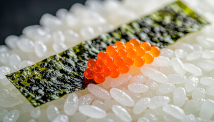 Sushi dressing with salmon roe and seaweed on a background of white rice 