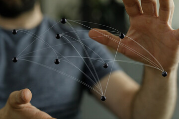 Image of person interacting with network spheres, representing connection, data, abstract concepts and technolo