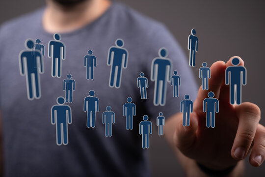 Hand pointing at human silhouettes representing network, connections, community, collaboration, and teamwork. C - Powered by Adobe