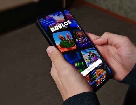 Belarus, Svetlogorsk, November 12, 2025. Point of View Shot Teen Playing - "Roblox" Game on Smartphone at Home. Cool Game with Modern Graphics and Fun Gameplay.