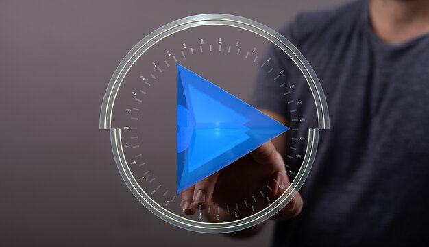 A person's hand interacting with a glowing futuristic play button or media concept, suggesting online streaming and digital technolog