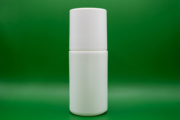Minimalistic white skincare or deodorant bottle on bright green background. Beauty and hygiene concept for cosmetics, organic care, and modern packaging. 