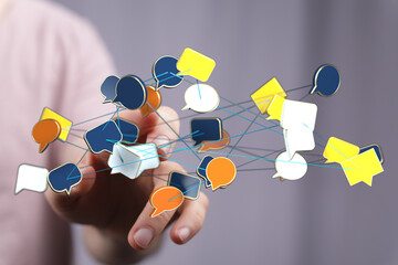 Concept of communication, social media, and networking. Hand connecting ideas via a digital network of speech b