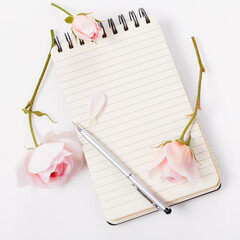 Vertical flat lay with open notebook, silver pen and pink roses on white background, elegant template for Pinterest design, journaling inspiration, feminine quote, lifestyle and self care concept