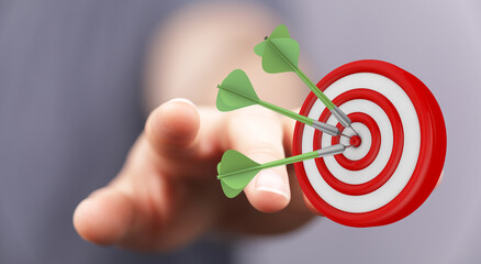 Concept of success, achieving targets, and strategic planning. Hand pointing towards a dartboard with darts. Symbolizes focus, precision, and bu