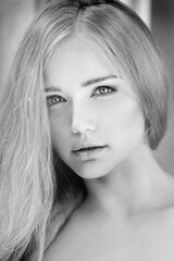 Naklejka premium Woman face close up. A pretty young blond trendy. Girl with a beauty face. Beautiful female face with luxury make-up