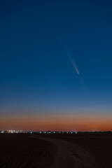 Spectacular Celestial Phenomenon: The Rare Comet ATLAS 2024 Visible Against a Deep Red Post-Sunset Sky During Astronomical Twilight