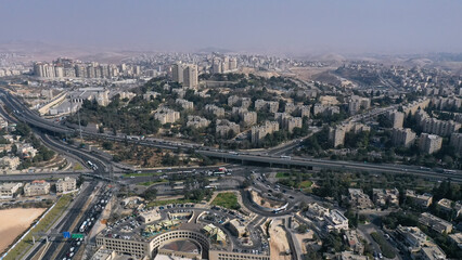 Fototapeta premium Aerial view of Highway 1 and French Hill interchange JerusalemA sweeping urban shot showing the busy French Hill junction, major roadways, and surrounding neighborhoods.