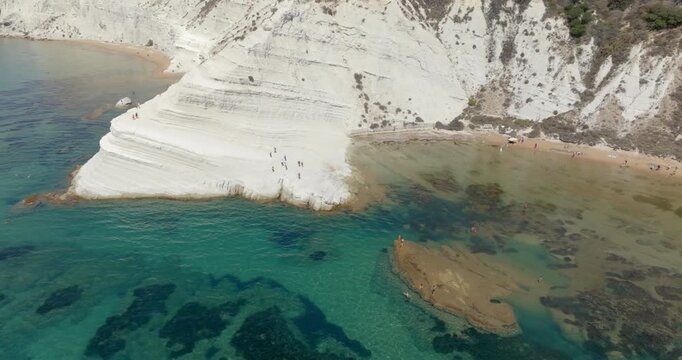 Aerial view of the Scala dei Turchi (Stair of the Turks or Turkish Steps) on the coast of Realmonte, near Agrigento, Sicily, Italy. It's a rocky cliff and tourist attraction. The sea is azure, crystal