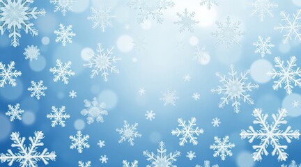Falling snow crystal patterns on soft blue winter bokeh background