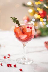 Pomegranate Champagne Spritz. Festive alcohol drink with pomegranate and lime slice  for eve christmas