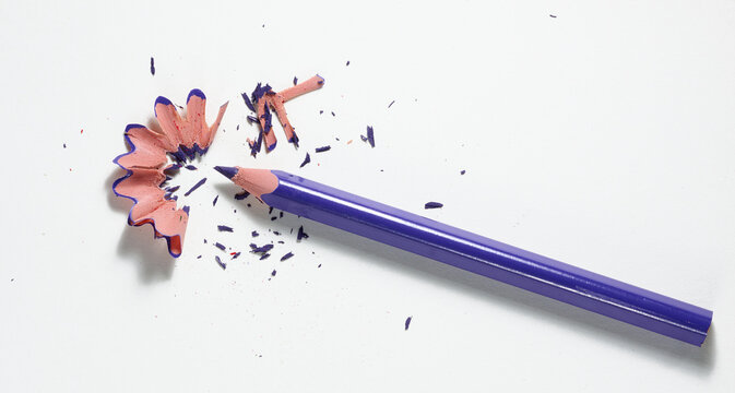 Purple pencil with shavings on white sheet of paper